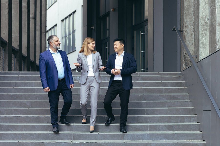 Diverse business team walking down stairs in a modern office