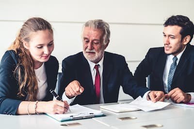 Senior executive in a confidential consultation with colleagues